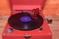 Image shows vintage gramophone famous Czech brand Supraphone. The red wind-up gramophone and vinyl record brand Ultraphon. Royalty Free Stock Photo