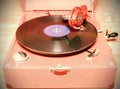 Image shows vintage gramophone famous Czech brand Supraphone. The red wind-up gramophone and vinyl record brand Ultraphon. Ret