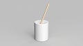 A white cylindrical container with a straw inserted. Royalty Free Stock Photo