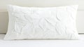 A white pillow with a leaf pattern. Royalty Free Stock Photo