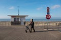Woman walking next to the beach on a sunny winter`s day in De Haan, Belgium
