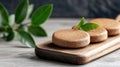 A wooden tray holds three round, brown, cork-like objects with green leaves on top. Royalty Free Stock Photo