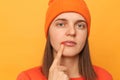 Image of sick unhealthy sick hipster woman wearing orange sweater and hat posing isolated over yellow background, suffering from