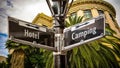 Signposts the direct way to Camping versus Hotel