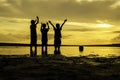 Image silhouette boys rise their hand and ball on the ring during sunset sunrise