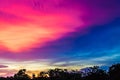 The image of the sky is light pink interspersed with dark blue. In the evening, near dusk, clouds obscured the gloomy sunlight. Royalty Free Stock Photo