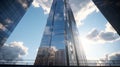 An image of a skyscraper taken at its foot, the mirror coating reflecting a clear sky with clouds