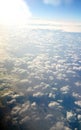 Little fluffy white clouds over a blue quiet sea