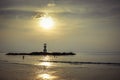 Image of small lighthouse against a tropical ocean sunset and smooth water at Khao Lak Beach in Phang Nga,Thailand. Royalty Free Stock Photo