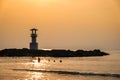 Image of small lighthouse against a tropical ocean sunset and smooth water at Khao Lak Beach in Phang Nga,Thailand. Royalty Free Stock Photo