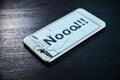 Image of smartphone with broken screen and the word Nooo!!! on it Royalty Free Stock Photo