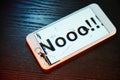 Image of smartphone with broken screen and the word Nooo!!! on it Royalty Free Stock Photo
