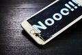 Image of smartphone with broken screen and the word Nooo!!! on it Royalty Free Stock Photo