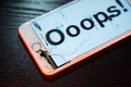 Image of smartphone with broken screen and the word Ooops! on it Royalty Free Stock Photo