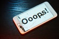 Image of smartphone with broken screen and the word Ooops! on it Royalty Free Stock Photo