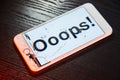 Image of smartphone with broken screen and the word Ooops! on it Royalty Free Stock Photo