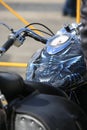 Image of a smiling demon on a motorcycle fuel tank, closeup. Palace Square Royalty Free Stock Photo