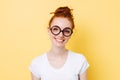 Image of smiling ginger woman in yeglasses looking at camera