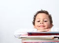 Little boy leaning on his school books Royalty Free Stock Photo