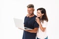 Cheery positive adult loving couple isolated over white wall background using laptop computer Royalty Free Stock Photo