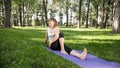 Photo of smiling woman doing yoga and fitness exercises. Middle aged people taking care of their health. Harmony of body