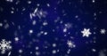 Image of snow flakes falling on blue background Royalty Free Stock Photo