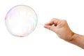 soap bubble and a males hand with needle to let it pop Royalty Free Stock Photo