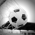 Soccer football in Goal net with the sky field.