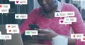 Image of social media icons over african american woman with face mask using smartphone