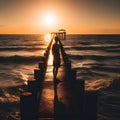 image of a solitary figure standing at the end of the jetty, the sun\'s last rays of light illuminating the distant horizon. Royalty Free Stock Photo