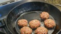 Frikadeller in a black pan