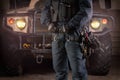 Image of a special unit soldier in front of a military truck. Military security concept