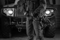 Image of a special unit soldier in front of a military truck. Military security concept