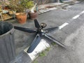 Spoiled black ceiling fan thrown on the street