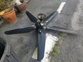 Spoiled black ceiling fan thrown on the street