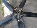 Spoiled black ceiling fan thrown on the street