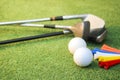 Colorful golf balls, clubs and tees lay on the green grass Royalty Free Stock Photo