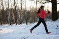 Image of sports woman on run through winter forest Royalty Free Stock Photo