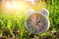 Image of spring Time Change. Summer back concept. Vintage alarm Clock outdoors. Royalty Free Stock Photo