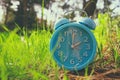 Image of spring Time Change. Summer back concept. Vintage alarm Clock outdoors. Royalty Free Stock Photo