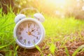 Image of spring Time Change. Summer back concept. Vintage alarm Clock outdoors. Royalty Free Stock Photo