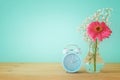 Image of spring Time Change. Summer back concept. Vintage alarm Clock over wooden table. Royalty Free Stock Photo