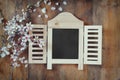 Image of spring white cherry blossoms tree next to wooden blackboard on blue wooden table. vintage filtered image Royalty Free Stock Photo