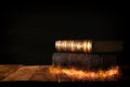 image of stack of antique books over wooden table and dark background.