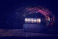 image of stack of antique books over wooden table and dark background.