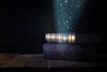 image of stack of antique books over wooden table and dark background. Royalty Free Stock Photo