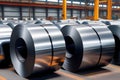 Rolls of shiny metal coils in a warehouse. Industrial background. Steel production Royalty Free Stock Photo