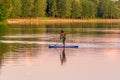 Image of stand up paddleboarding man on a lake Royalty Free Stock Photo