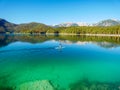 Image of stand up paddling on a beautiful mountain lake in autumn