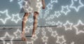 Image of star icons over african american woman walking at beach Royalty Free Stock Photo